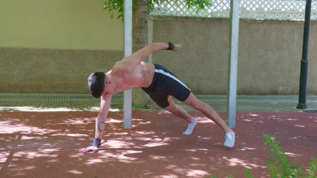 Athlete performing archer push ups outdoors for upper body strength