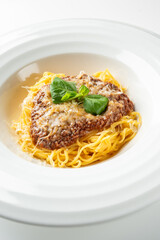 Spaghetti with hearty meat sauce and fresh basil served on a white plate, isolated on white background. Ideal for Italian cuisine, lunch, or dinner food concepts
