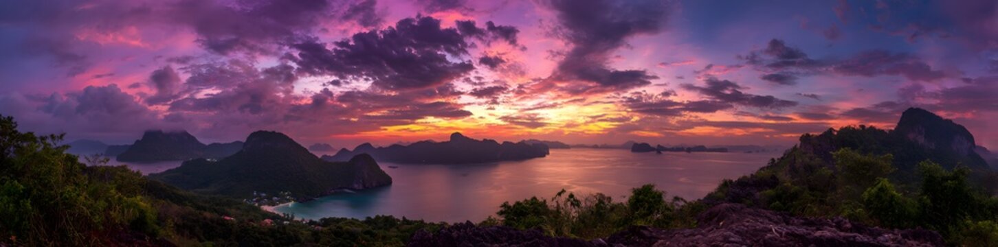8k Panoramic view of a colorful sunset over the sea with mountains in Thailand, banner 