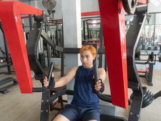 Asian men use gym equipment to do tricep, chest, arm exercises, focusing on building strength and...