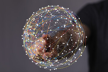 Abstract image of a hand interacting with a digital global network. Represents connection,...