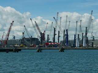 Silhouettes of Heavy-duty cranes in the port of Rostock. Industrial atmosphere and economy. Copy...