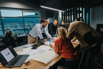 A group of multicultural employees engaged in a collaborative brainstorming session, discussing...