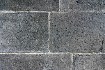 Old wall made of large gray blocks. Horizontal photo. Background