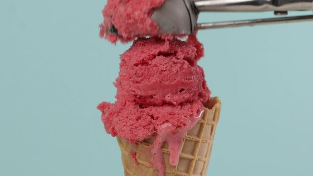 put melting pink sorbet in waffer coner blue background zoom