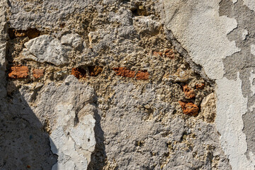 Crumbling wall close up shot , visible orange brick layers.