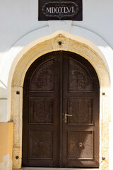 Old, hand carved oak wood door on old unitarian church close up shot.
