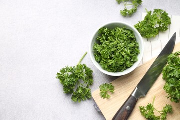 Fresh parsley and knife on light table, flat lay. Space for text