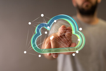 Person interacting with a digital cloud, representing data storage and network technology.