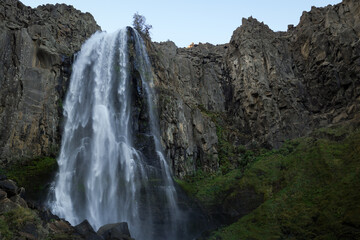 Imposing La Fragua Waterfallin a rocky Patagonian landscape. Manzano Amargo, Neuquen tourist destination, Argentina