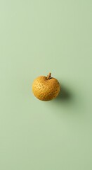 one longan fruit on a plain pastel background