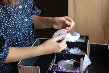 Woman Organizing Sewing Supplies at Home Craft Space