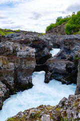 Marvel at the stunning beauty of Barnafoss and Hraunfossar in Icelands stunning landscape