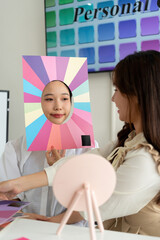Stylist consulting client with color palettes in creative studio