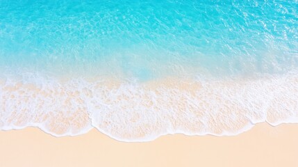 Aerial view of a pristine beach with turquoise water gently lapping against soft, sandy shores, capturing tranquil coastal beauty.