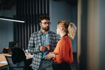 Diverse business people engage in a discuss within a modern office environment, emphasizing...