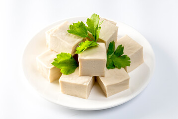 Fresh Sliced Soft Tofu soy bean curd on white plate