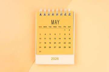May 2026 mini desk calendar on the yellow, planning for business meeting concept.