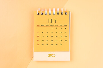 July 2026 mini desk calendar on the yellow, planning for business meeting concept.