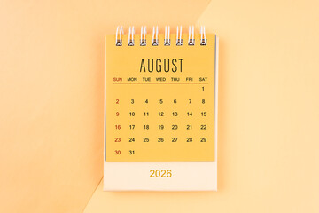 August 2026 mini desk calendar on the yellow, planning for business meeting concept.