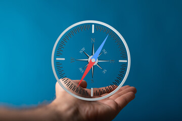 A hand gently holds a compass, symbolizing guidance and direction. Perfect for business, travel, or...