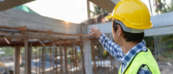 inspector, engineer, Foreman or contactor point on construction for inspect the quality of his work. architects work to build the house before handing it over to the homeowner. Develop new estate.