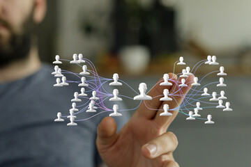 Image of a hand interacting with a digital network of people, representing global connections and...