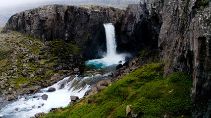 Folaldafoss waterfall in Berufjardara river has a drop of approximately 20 meters that look...