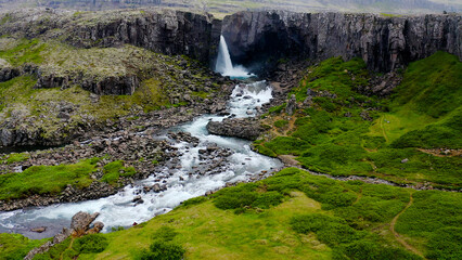 Folaldafoss waterfall in Berufjardara river has a drop of approximately 20 meters that look...