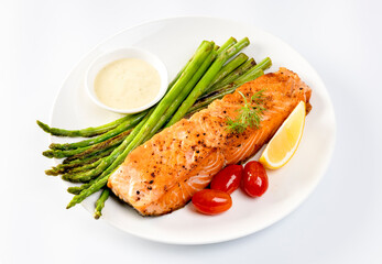 Grilled Salmon with Asparagus, Tomatoes and Lemon on White Plate