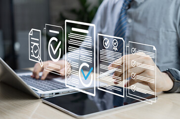 Document review and quality control concept. Businessman using laptop and tablet with checkmark and...
