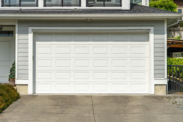 Garage door in luxury house with trees and nice landscape in Spring in Vancouver, Canada, North...
