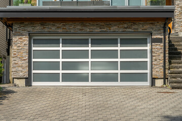 Garage door in luxury house with trees and nice landscape in Spring in Vancouver, Canada, North...