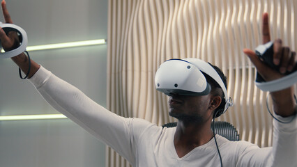African American ethnic man male guy playing VR game innovation internet gaming interactive...