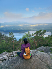 Stunning view from a rocky outcrop in Norway with a hiker enjoying natures beauty