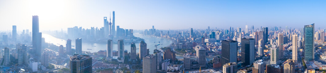 Aerial view of Shanghai skyline with winding river at sunrise.