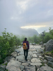 Exploring the scenic hiking trails of Norway under a misty sky