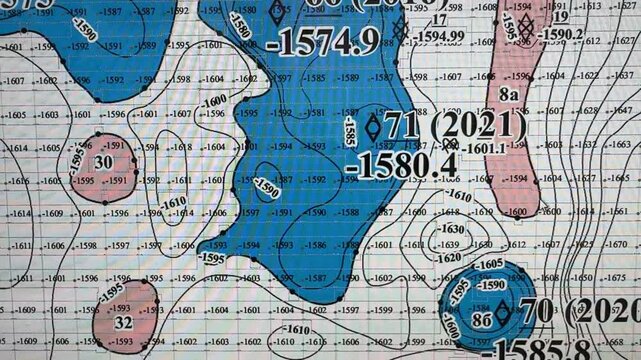 A digital elevation map displays terrain height variations in vivid colors for geological analysis on a computer screen.