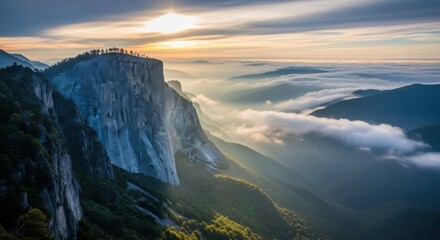Sunrise over majestic mountain cliff, fog-covered valley, scenic landscape