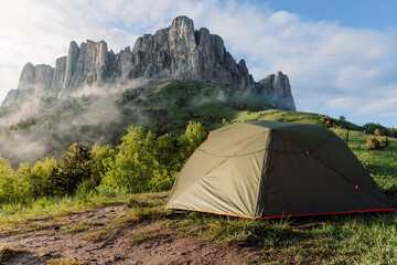 Scenic camping spot in the mountains with a tent at sunrise, Bolshoy Tkhach national park