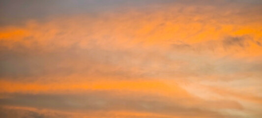 In the evening. the sky and clouds are orange.