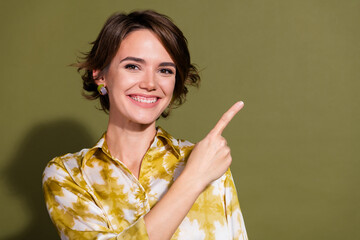 Confident young businesswoman against a khaki background in a stylish blouse, ideal for corporate...