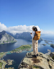 Breathtaking view from a mountain peak overlooking the fjords of Norway under a clear blue sky