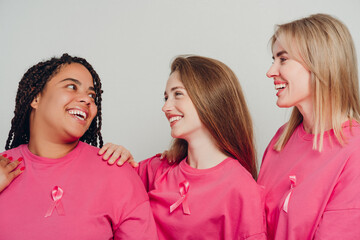 Diverse group of beautiful women smiling and supporting breast cancer awareness