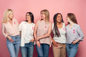 Diverse women smiling and supporting breast cancer awareness together