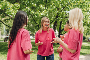 Volunteers wearing pink t-shirts supporting breast cancer awareness campaign in park