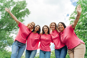 Smiling women embracing and supporting breast cancer awareness