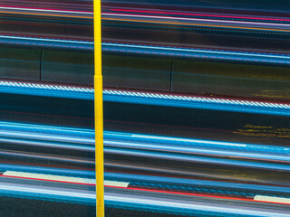 Dynamic light trails from cars on a Swedish motorway during the night create a vibrant visual experience