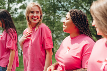 Volunteers wearing pink ribbons supporting breast cancer awareness month