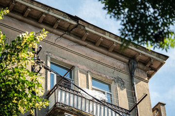 Crack running through building show earthquake damage, consequences of seismic activity. Aging infrastructure, dilapidated housing stock, lack of maintenance, structural vulnerability, urban decay